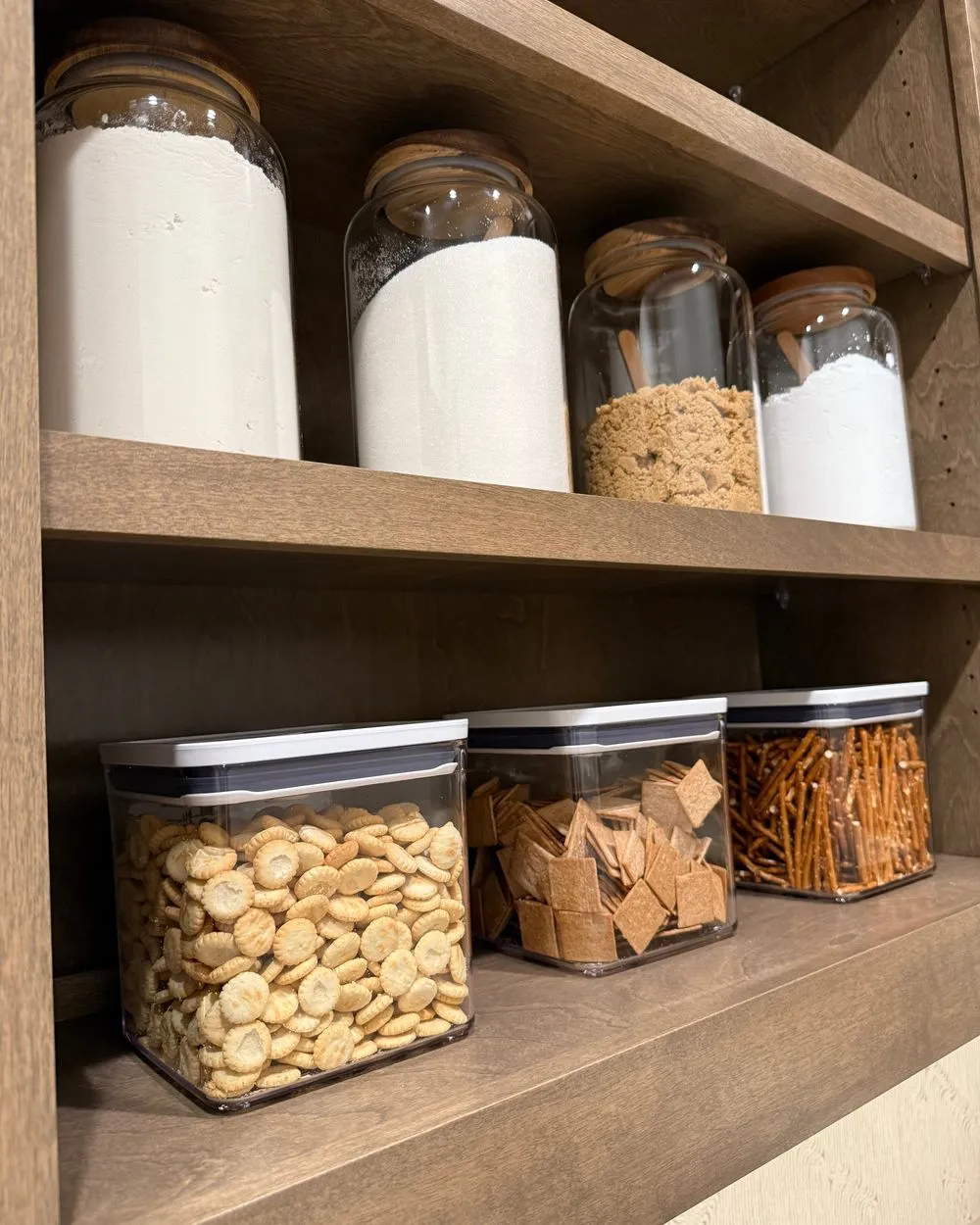 Organized pantry with labeled glass canisters